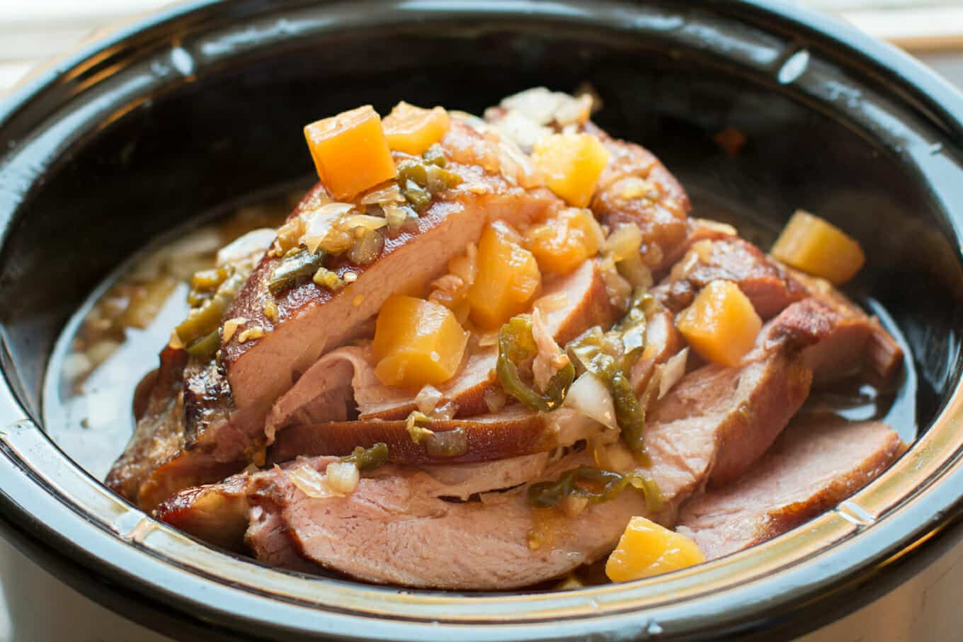 Sliced pineapple jalapeno ham in slow cooker.