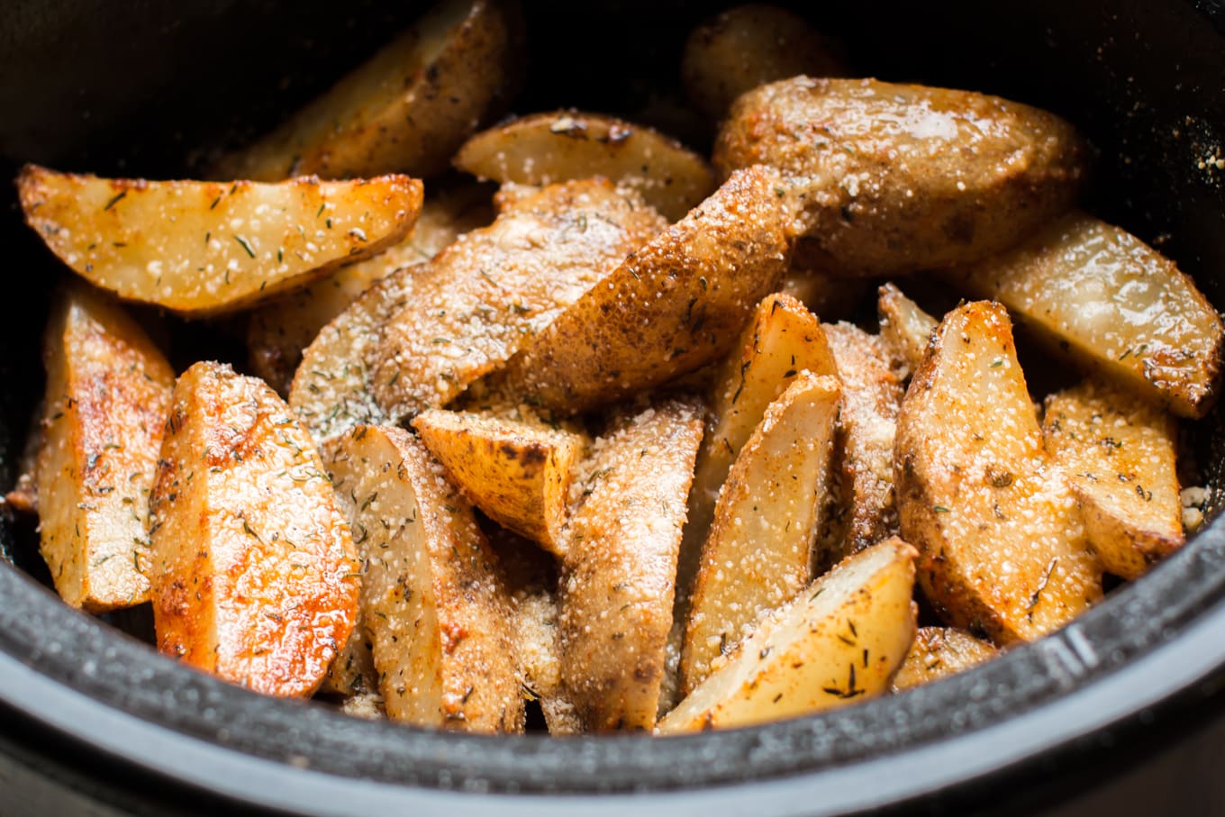 Close up of potato wedges in slow cooker.