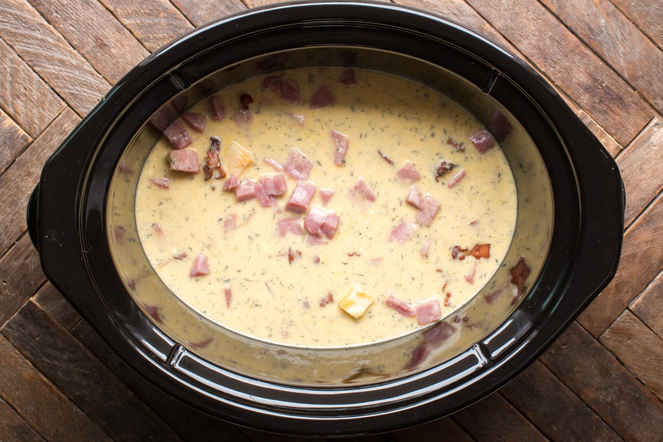 raw eggs and ham in a slow cooker