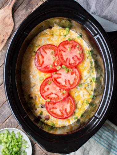 meaty egg casserole with tomatoes on top.