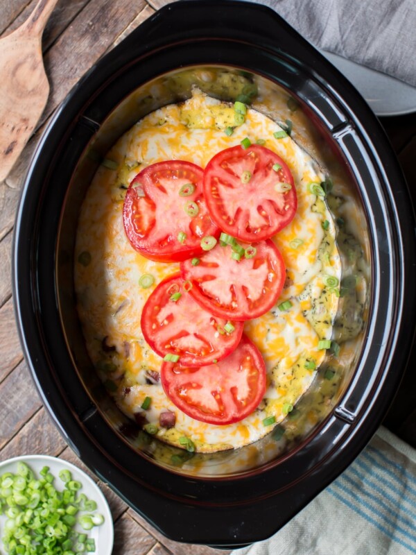 meaty egg casserole with tomatoes on top.