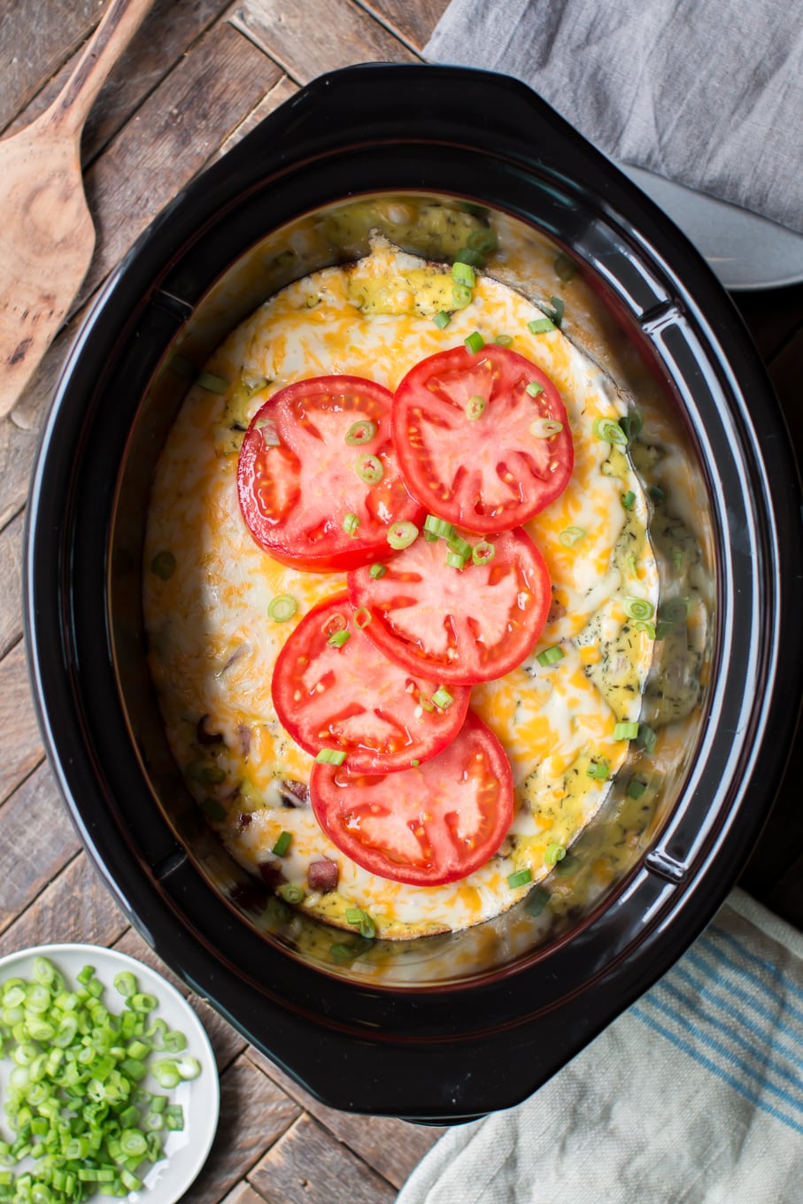 meaty egg casserole with tomatoes on top.