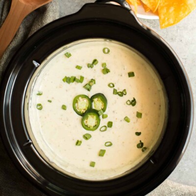 white queso in a round slow cooker