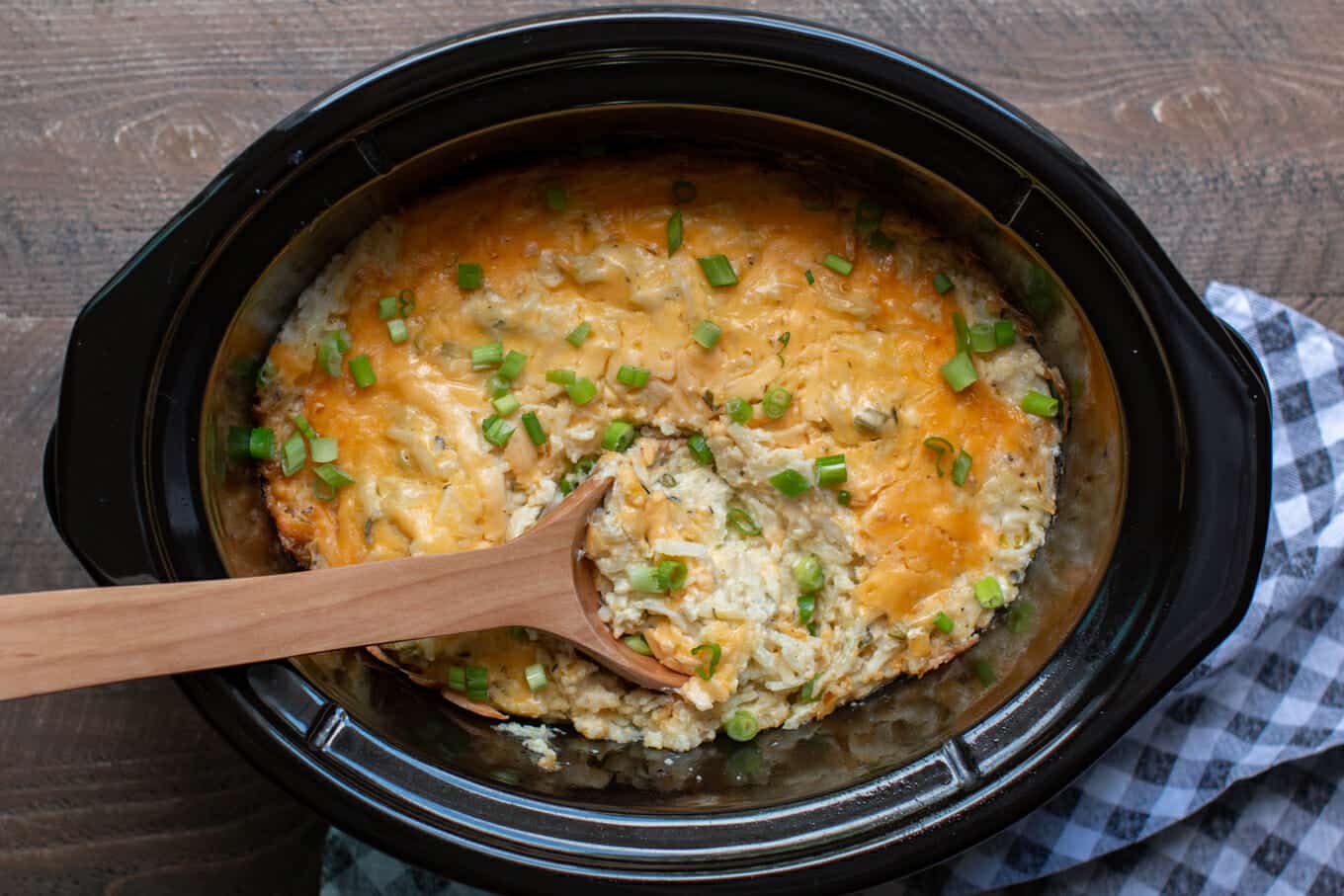 finished cooking shredded cheesy potatoes in a slow cooker.