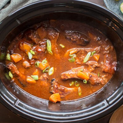 individual ribs in slow cooker with peaches and green onions