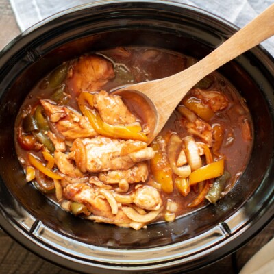 chicken tenders with bell peppers and onion in barbecue sauce.