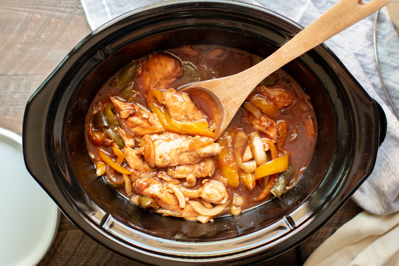 cooked chicken in barbecue sauce in a slow cooker