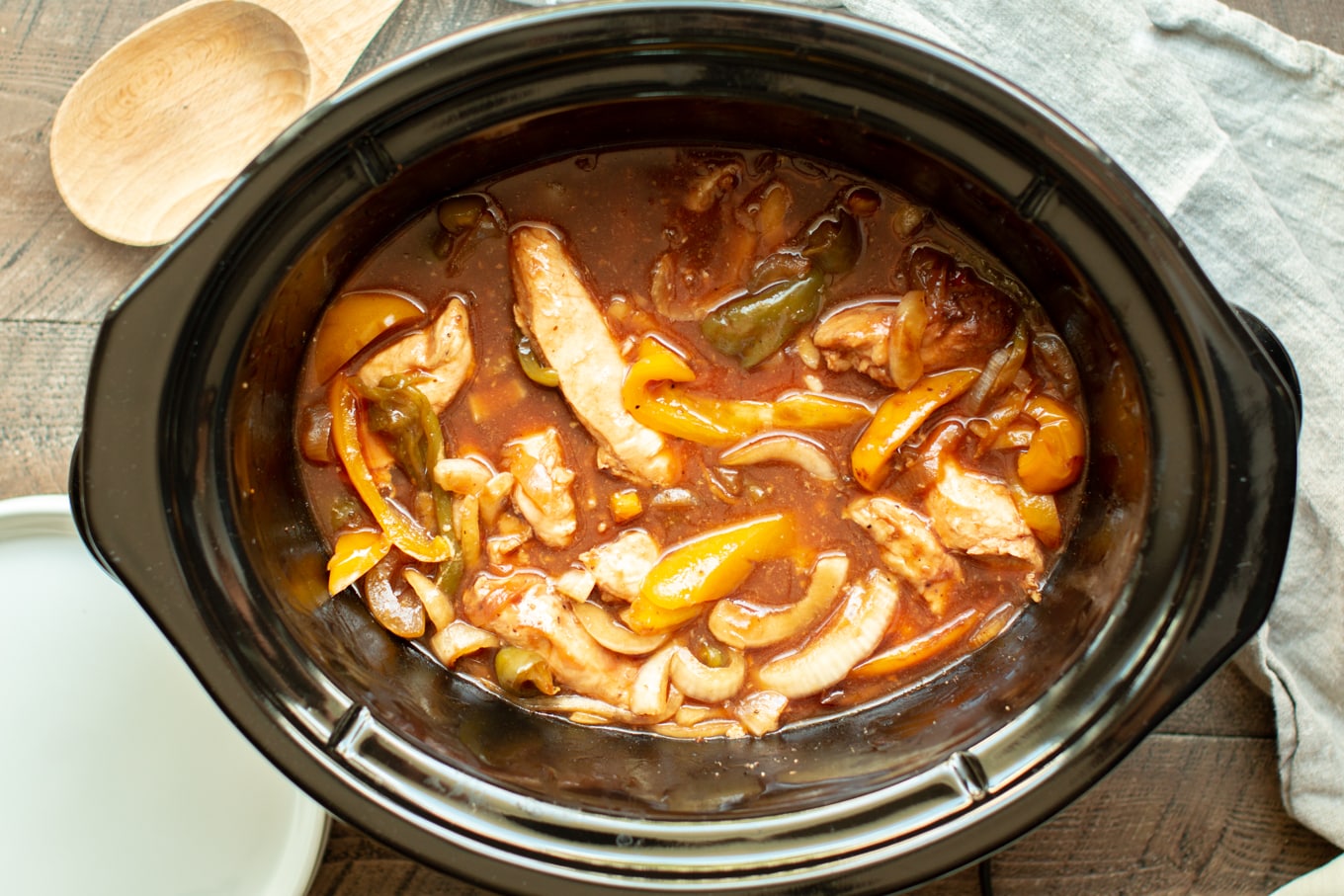 cooked chicken in barbecue sauce with bell peppers and onions