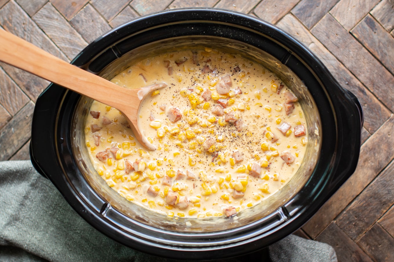 corn in a cheesy sauce with black pepper on top.