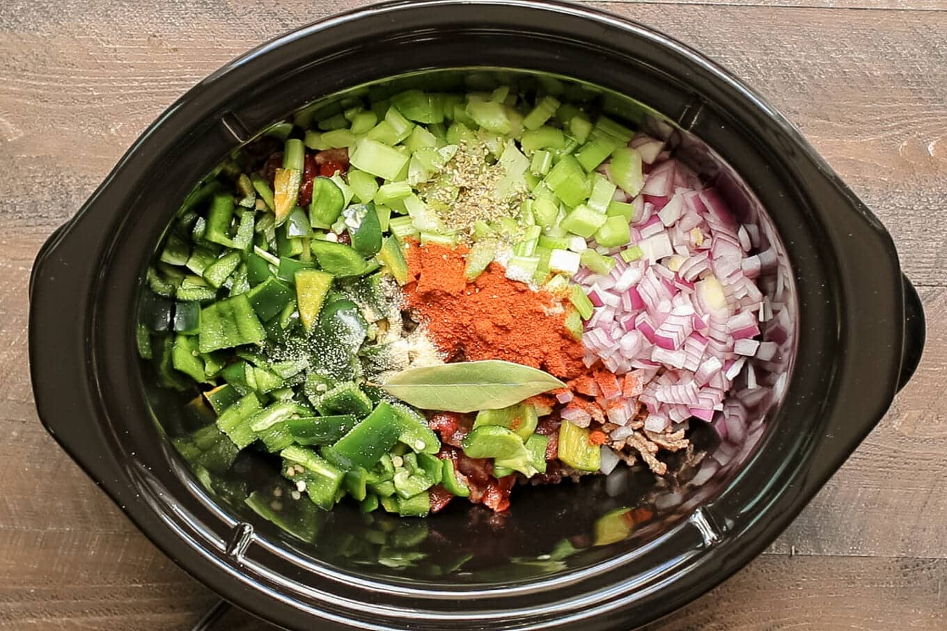 bell pepper, celery, red onion, chili powder and bay leaf in slow cooker