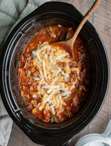 low carb chili in slow cooker with wooden spoon in it.