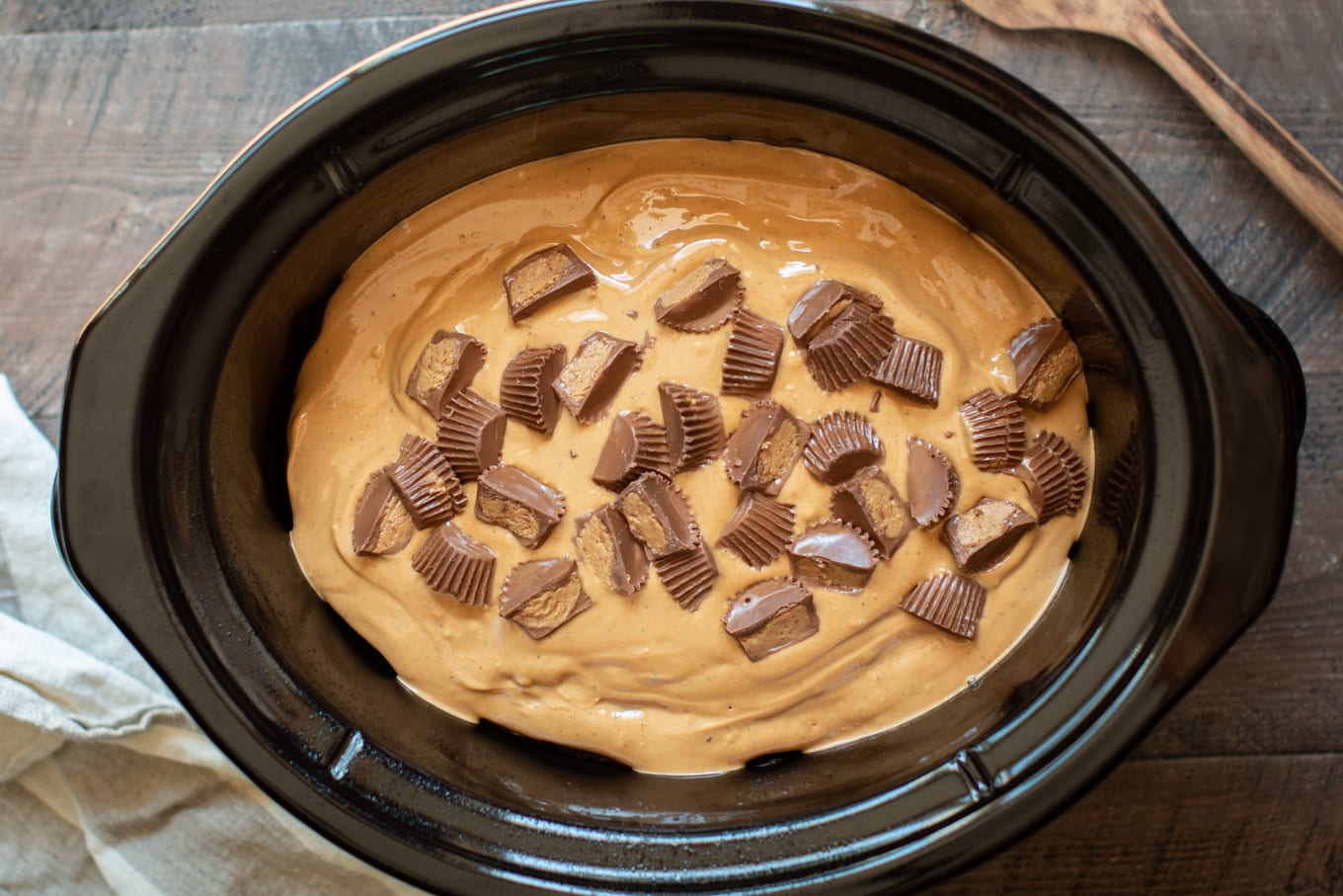 chocolate cake with warm peanut butter icing on top. With peanut butter cups on top.