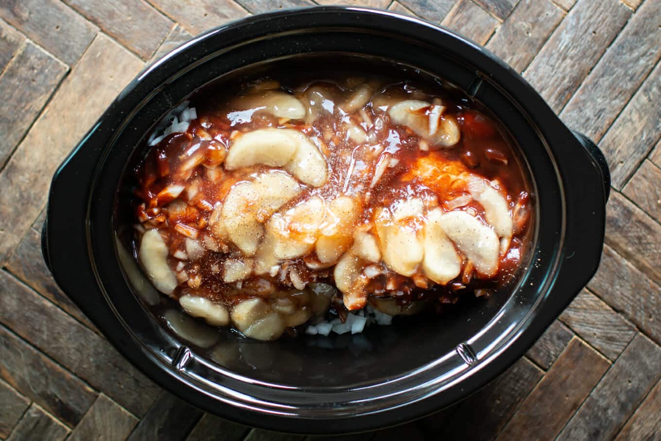 pork loin with onions, barbecue sauce and apple pie filling on top.