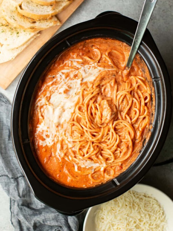 spaghetti in the slow cooker with a metal ladle