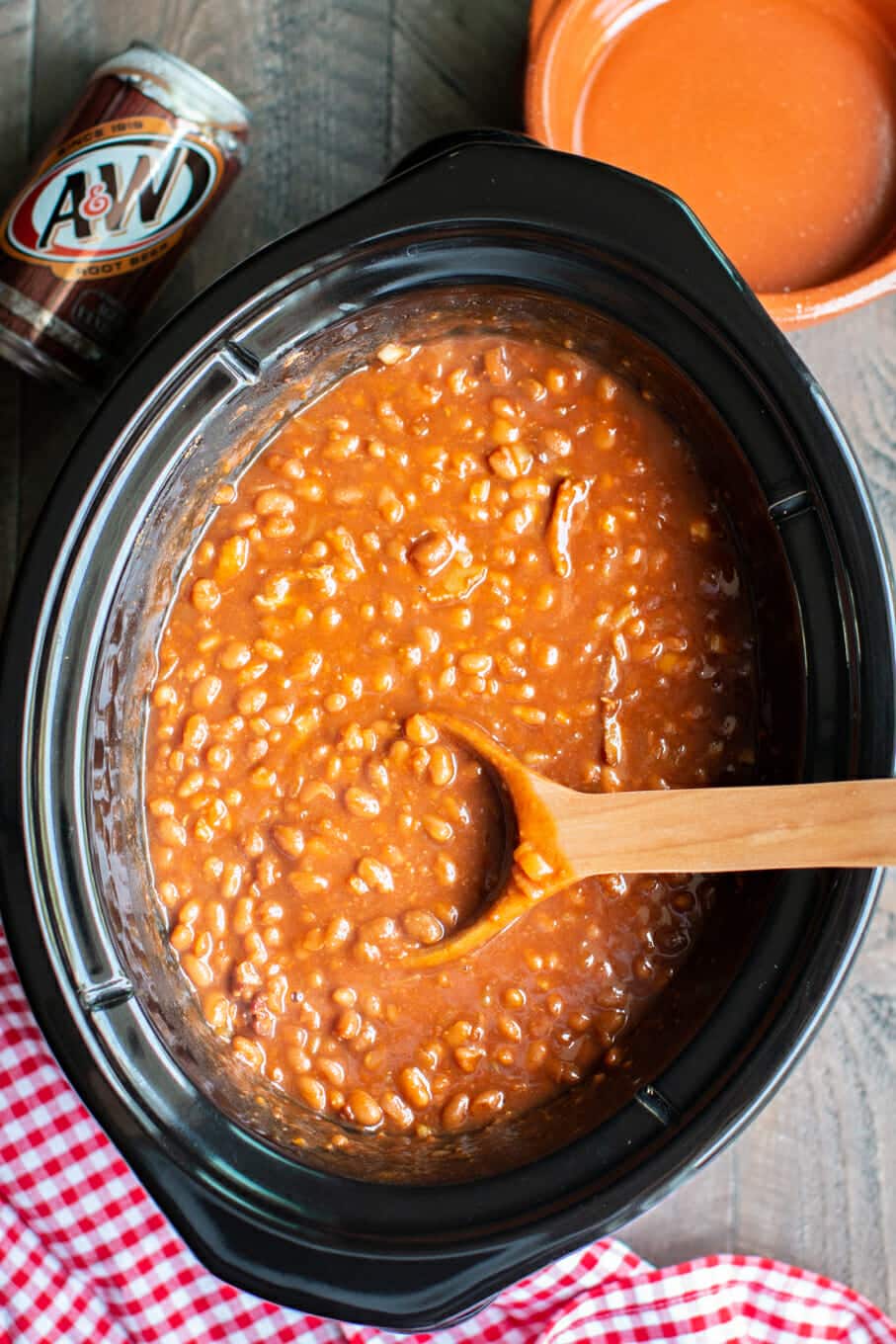 root beer bacon beans with wooden ladle