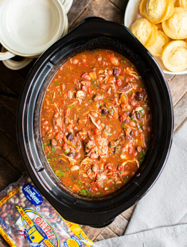 chicken chili in slow cooker with cilantro on top.