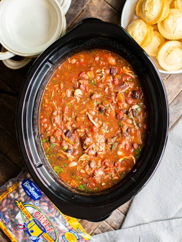 chicken chili in slow cooker with cilantro on top.