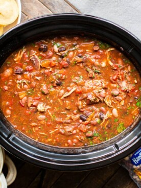 chicken chili in slow cooker with cornbread muffins on the side.