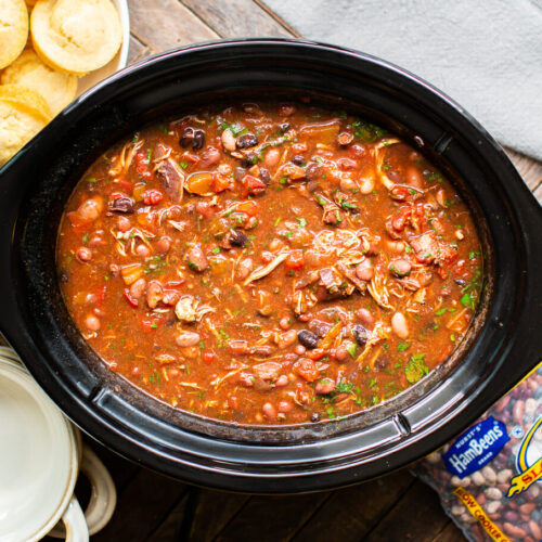 chicken chili in slow cooker with cornbread muffins on the side.