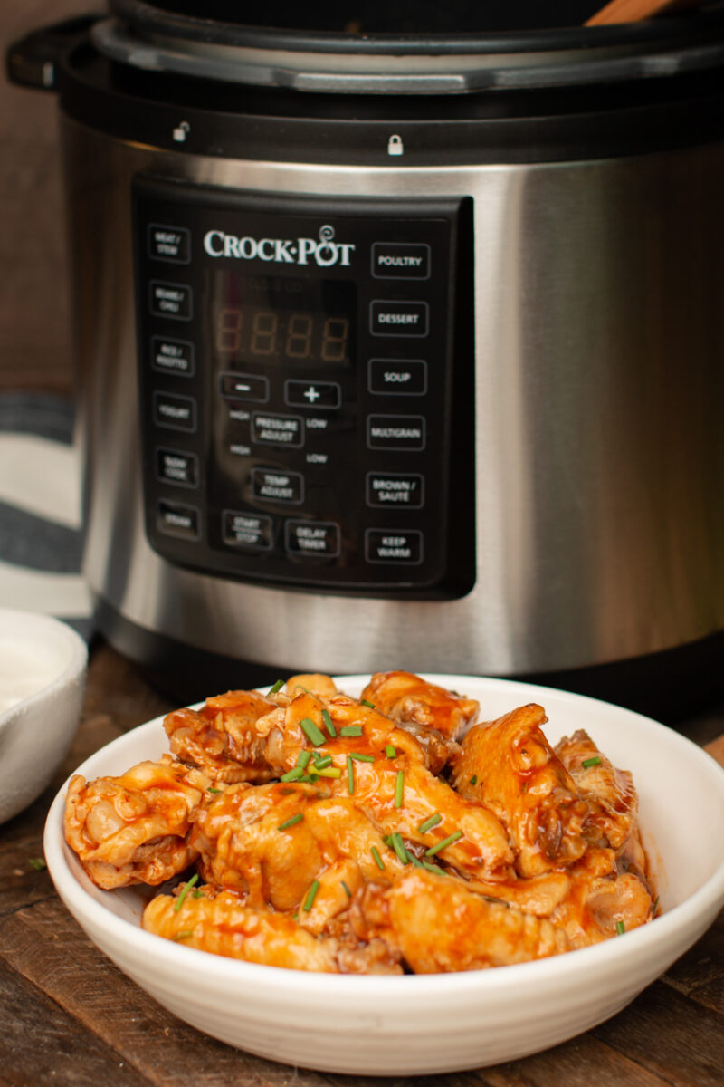 buffalo wings in front of a slow cooker