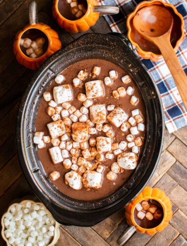 hot chocolate with pumpkin shaped mugs around the side