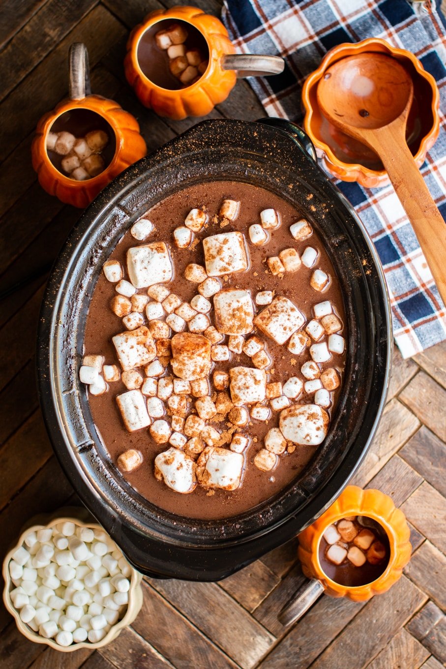 hot chocolate with pumpkin shaped mugs around the side