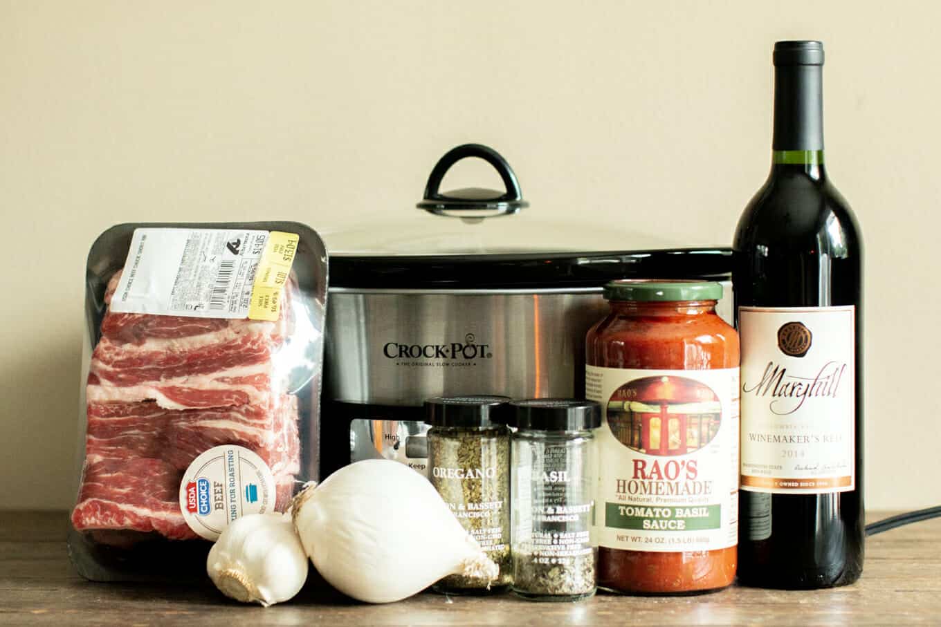 short ribs, seasonings, rao's marinara, onion and red wine in front of slow cooker.