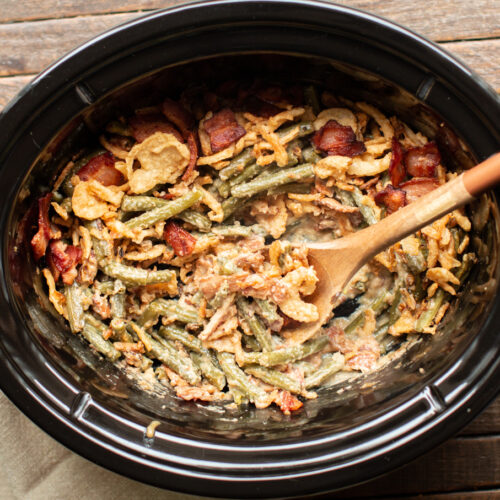 green beans in slow cooker with french fried onions on top