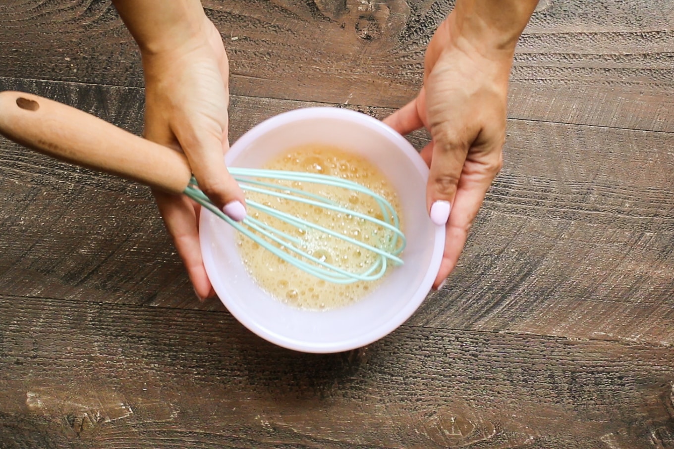 pink bowl with frothy egg white in it.