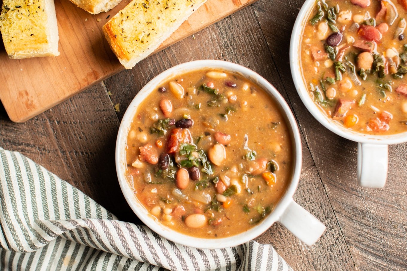 2 bowls of bean soup in white bowls.