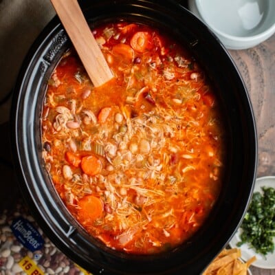 soup with buffalo sauce, carrots and variety of beans in a slow cooker.