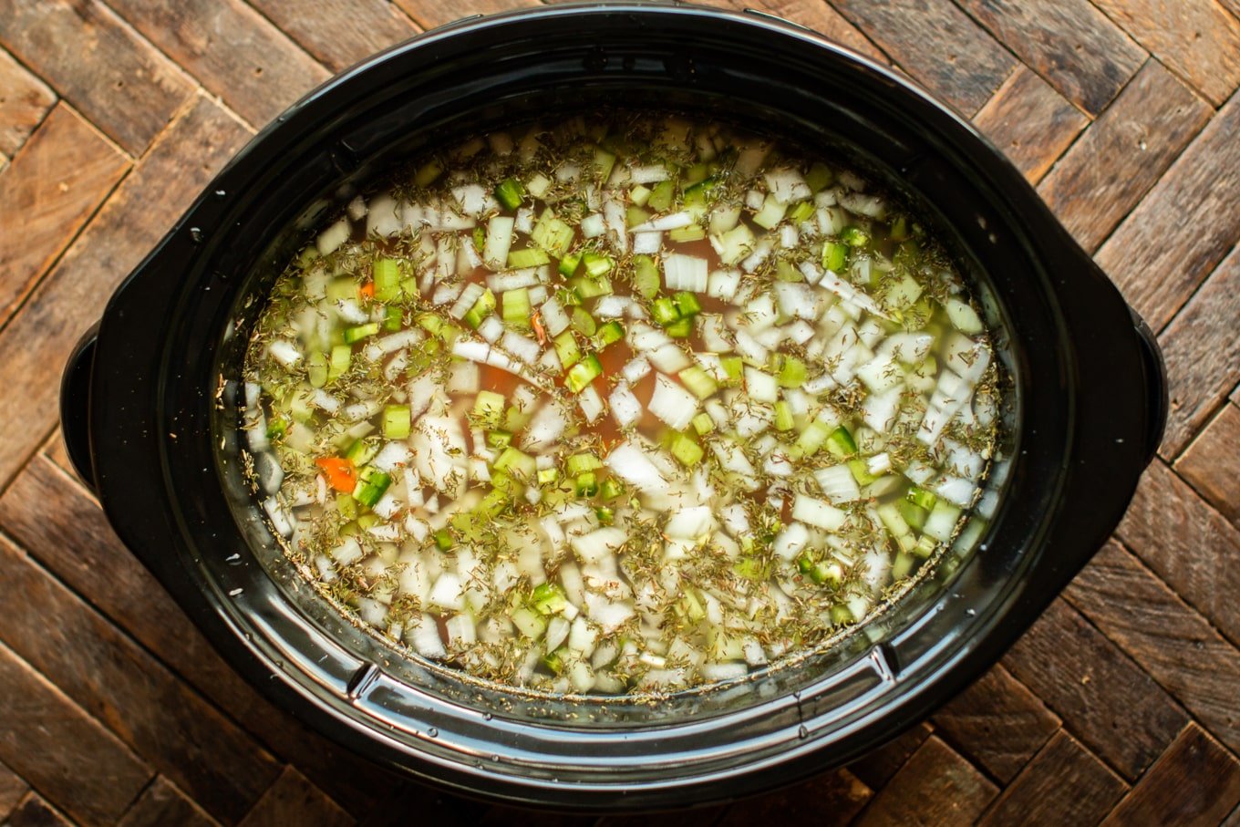 carrots, celery and onion in water in a slow cooker.