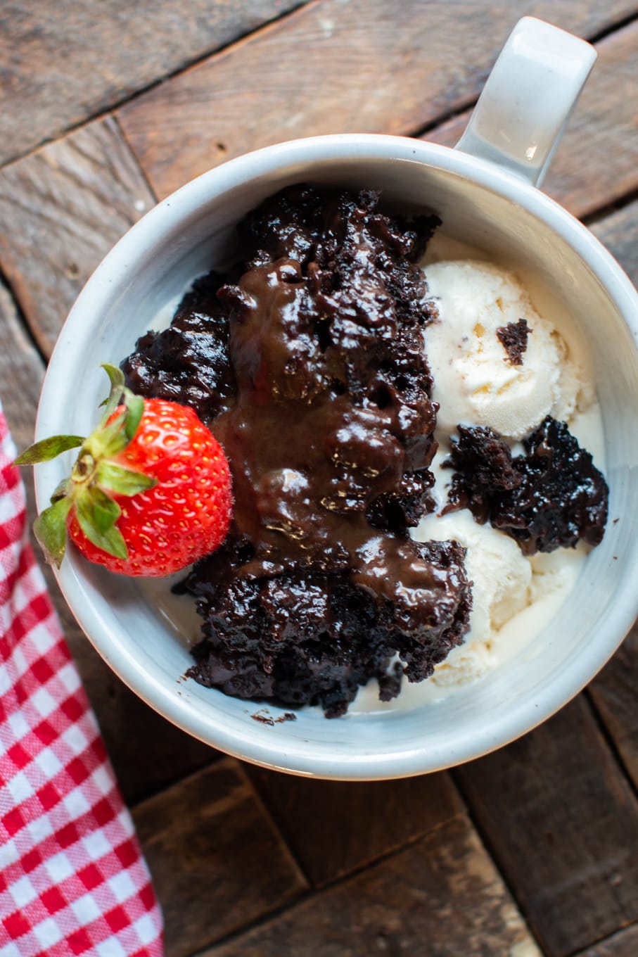 scoop of lava cake in a bowl with ice cream.