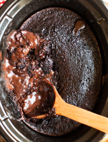 chocolate lava cake in a slow cooker with a spoon in it.