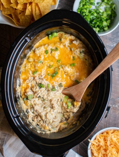 rice and chicken casserole with a wooden spoon in it.