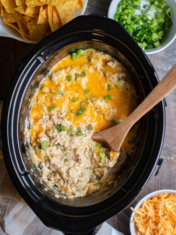 rice and chicken casserole with a wooden spoon in it.