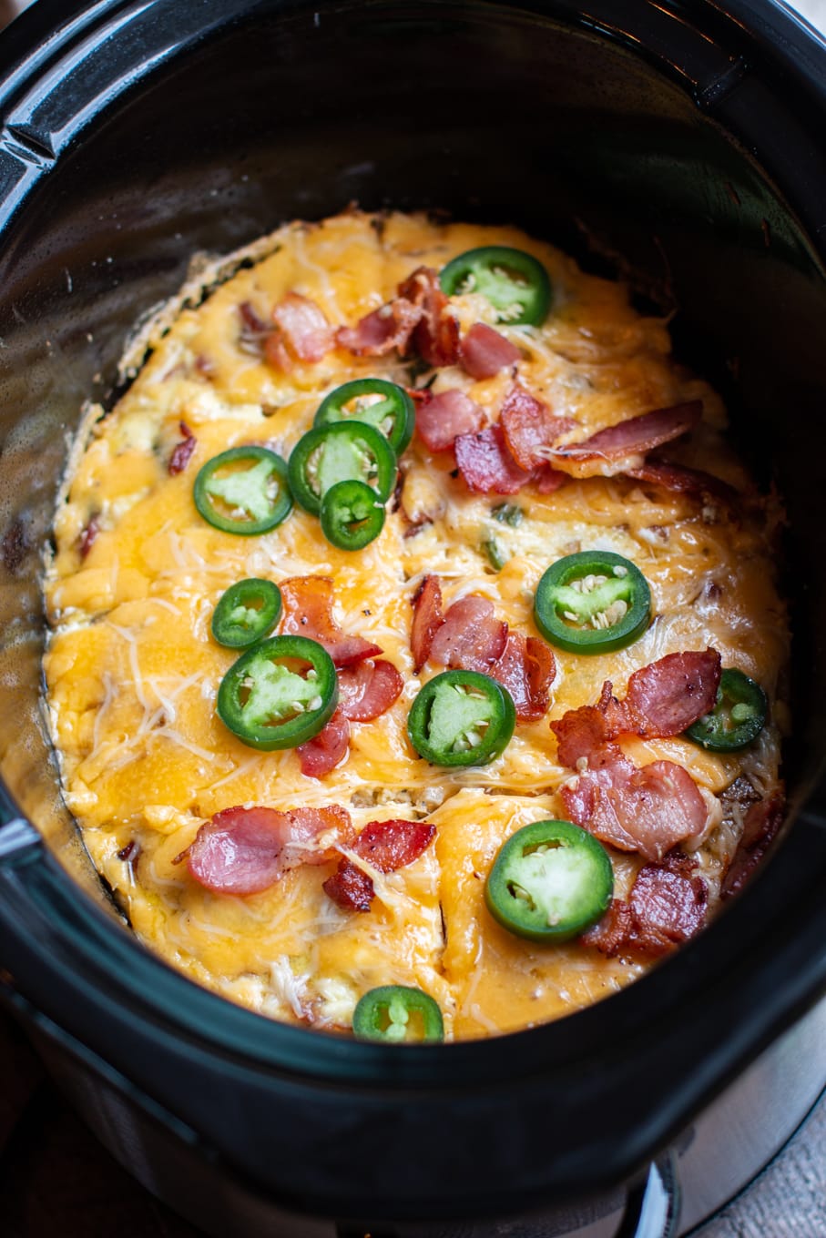 oval quiche in a slow cooker cut into slices.