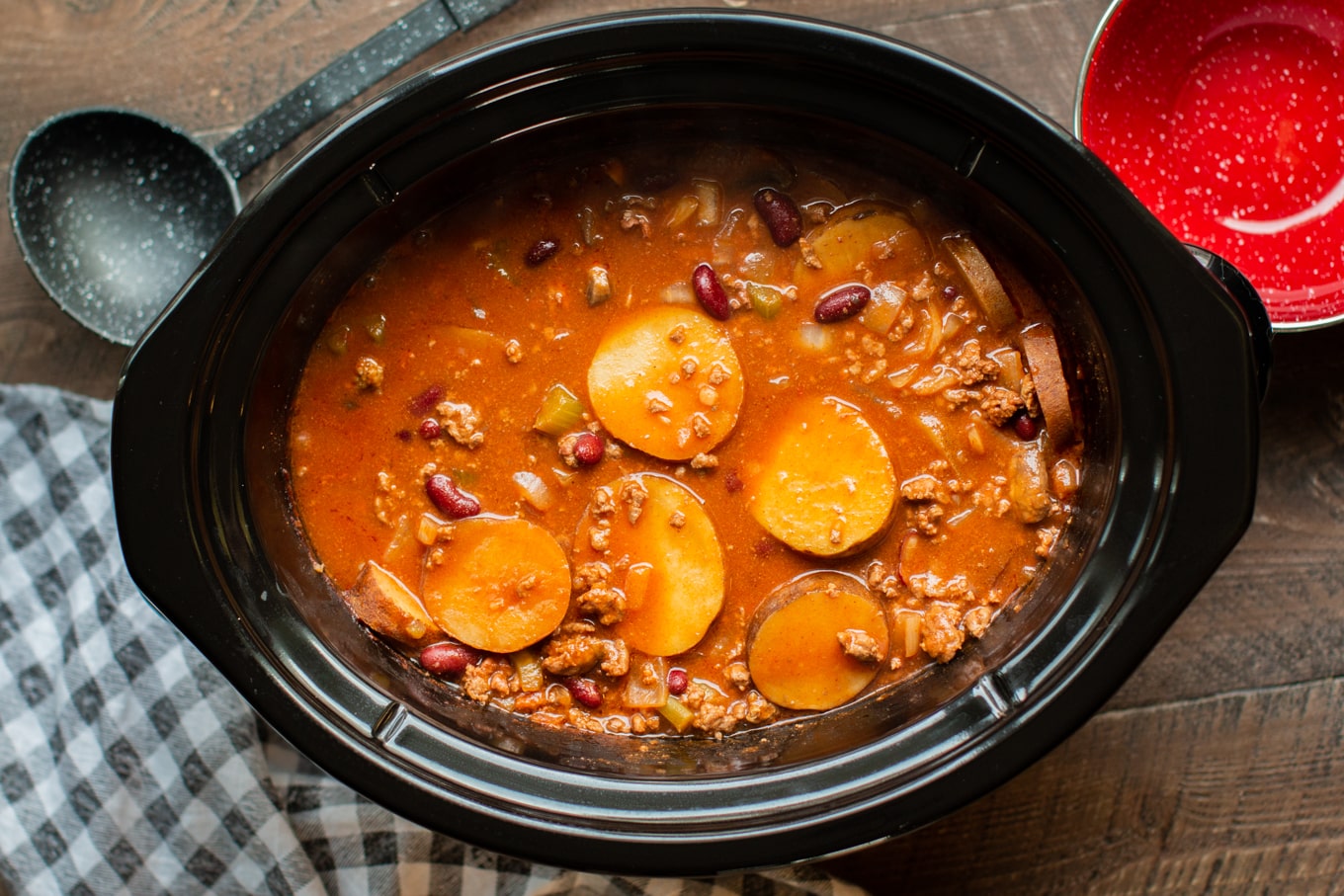 finished shipwreck stew in black slow cooker.