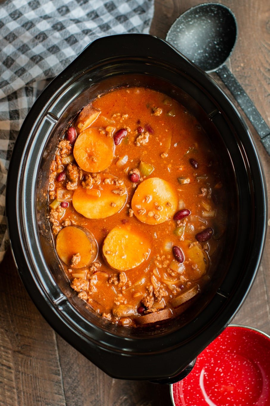 tomato based soup with sliced potatoes, kidney beans and ground beef in a slow cooker.