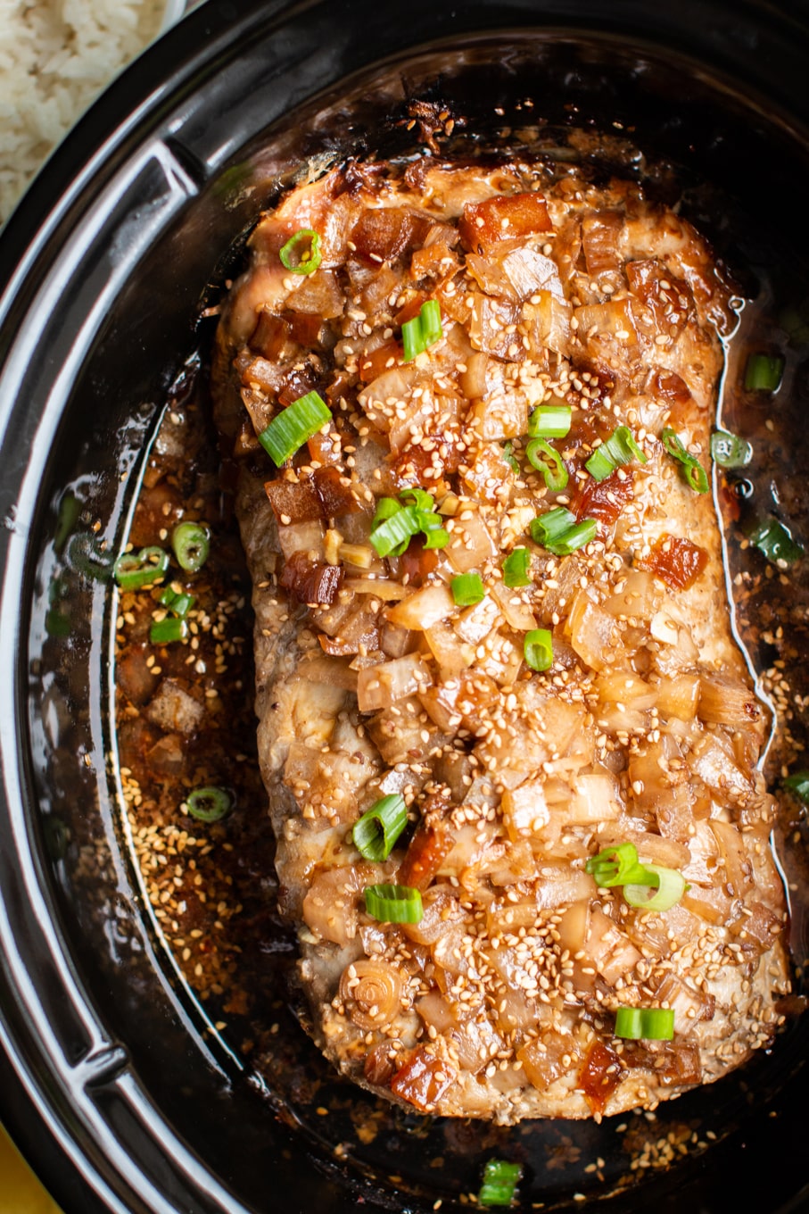 close up of cooked brown sugar sesame pork loin in a slow coker