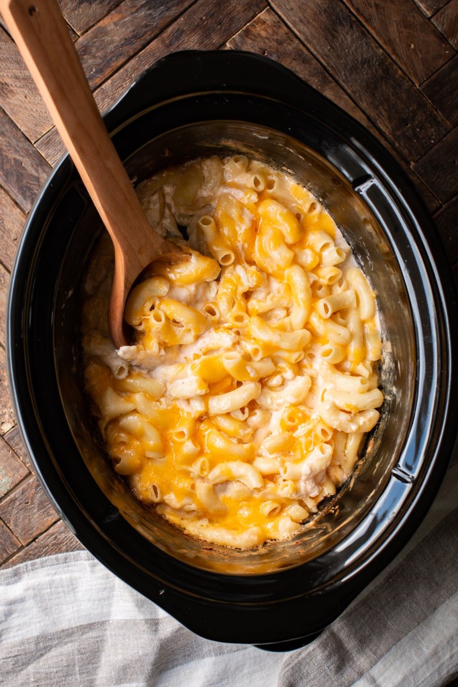 large elbow macaroni with cheese in an oval slow cooker.
