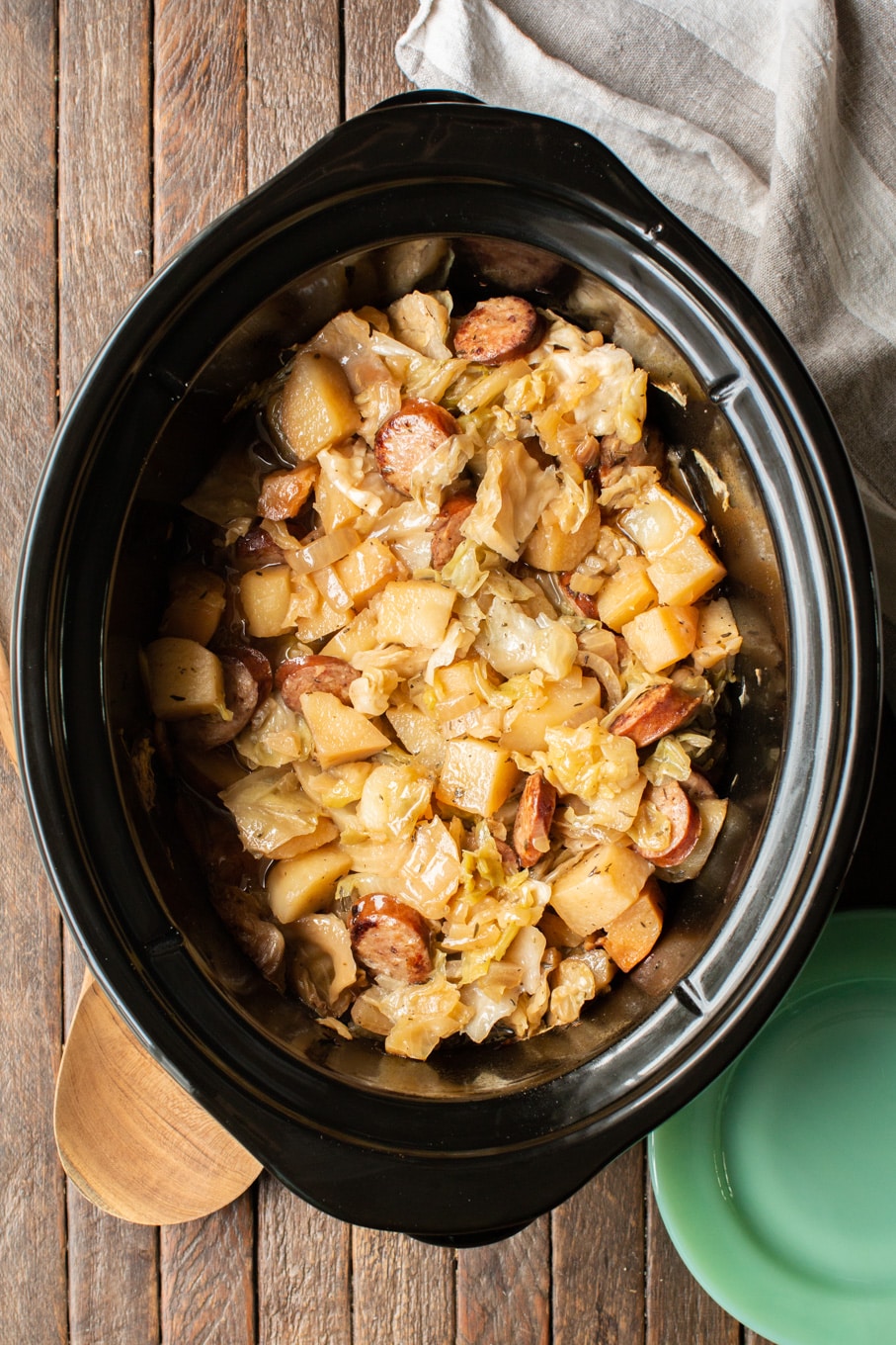 cooked potatoes, cabbage, and sliced kielbasa in a slow cooker.