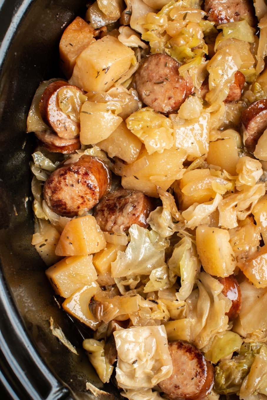 close up of cooked cabbage, potato meal in slow cooker.