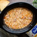 white beans and ham soup in slow cooker with cornbread on the side.