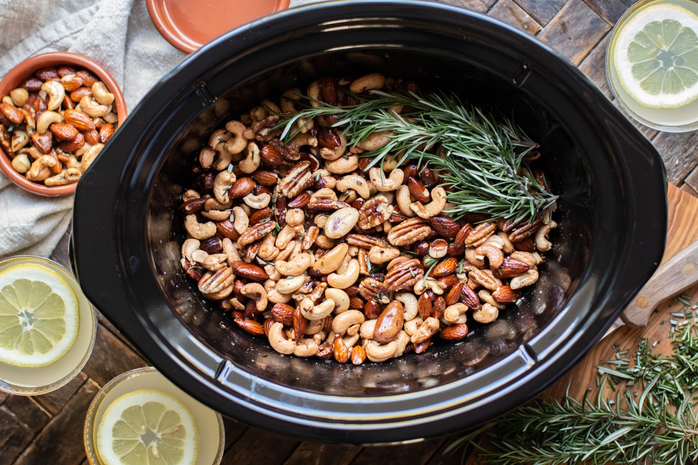 warmed nuts in a slow cooker with lemon drops on the side.