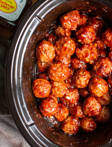 close up of barbecue meatballs in a slow cooker.