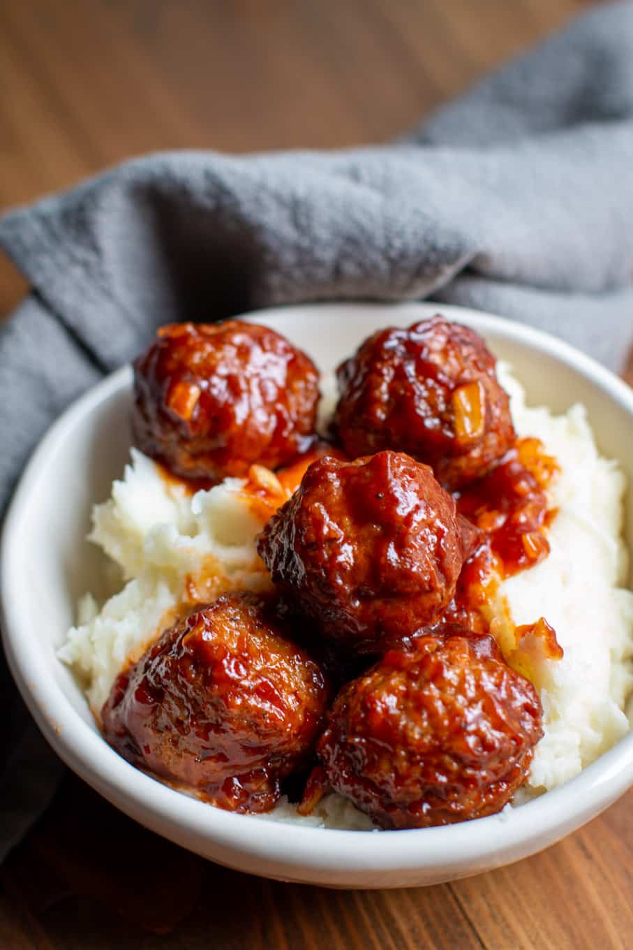 barbecue meatballs over mashed potatoes in a slow cooker.