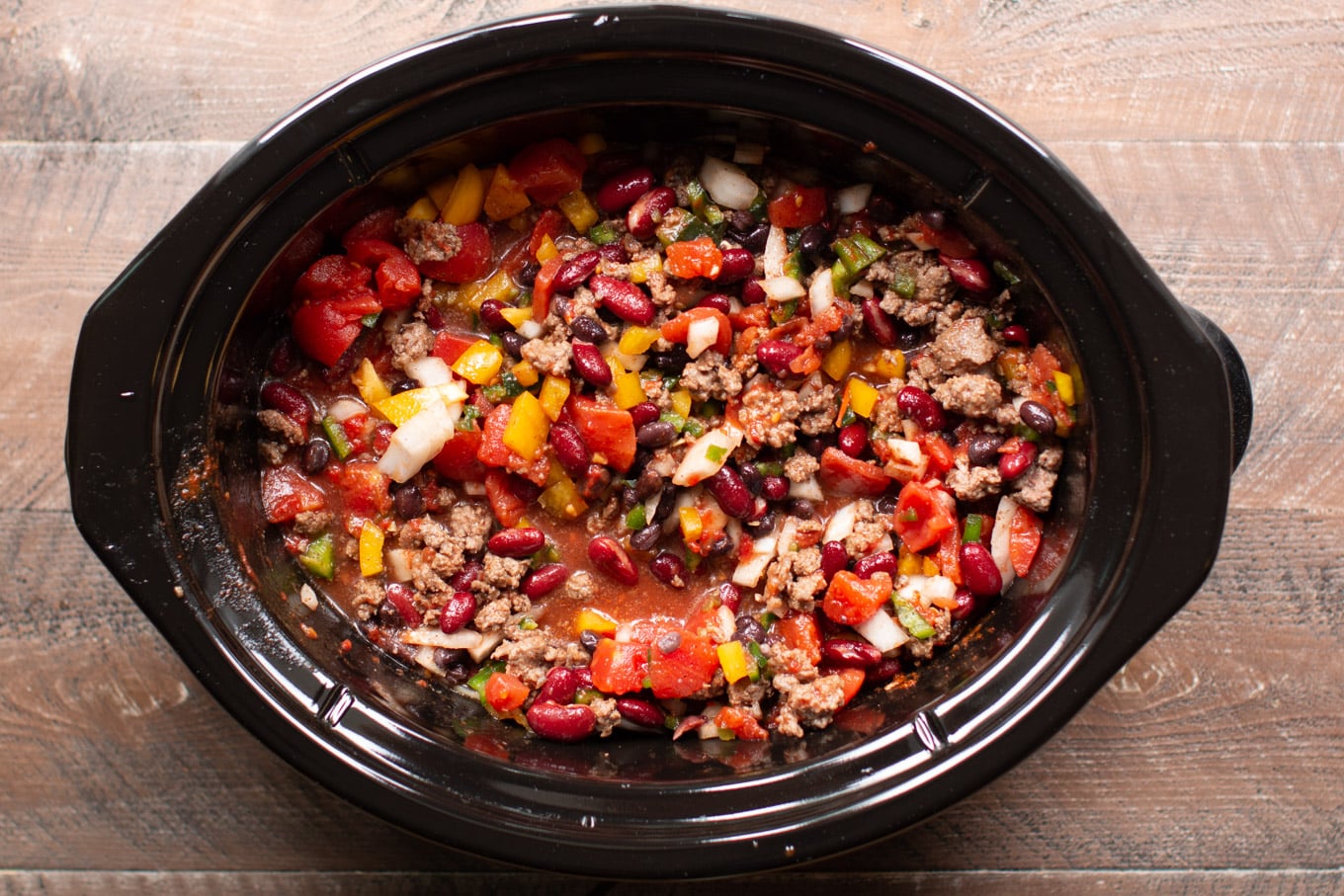 Uncooked chili in a slow cooker.