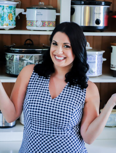 A woman standing in front of shelves full of slow cookers.