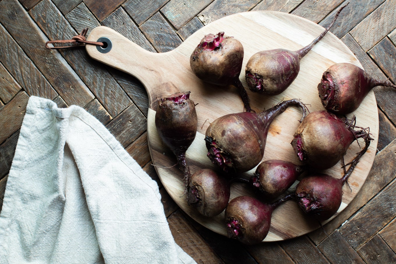 9 beets on a cutting board (uncooked).